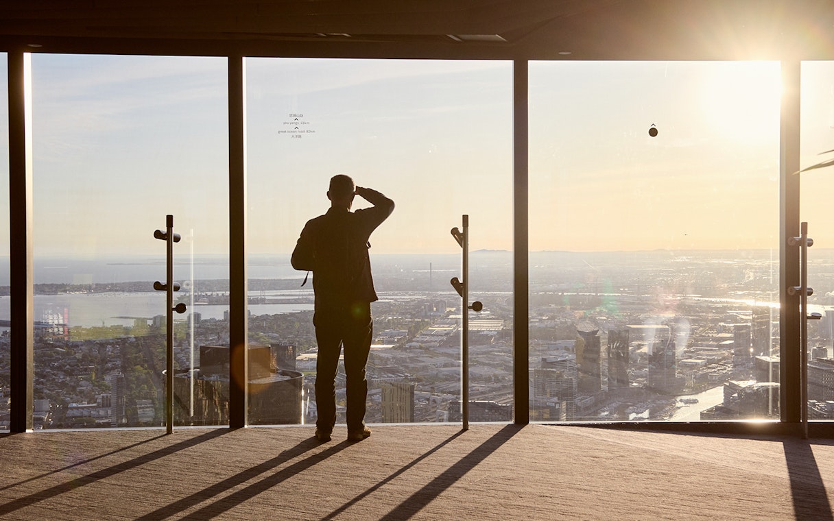 Person enjoying city view from Melbourne Skydeck at sunset, part of Max VR Experience.