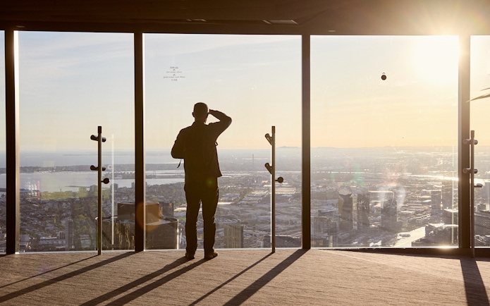Person enjoying city view from Melbourne Skydeck at sunset, part of Max VR Experience.