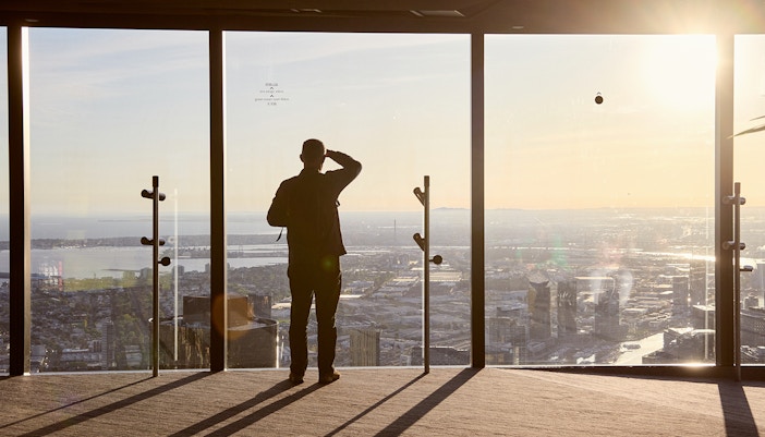 Person enjoying city view from Melbourne Skydeck at sunset, part of Max VR Experience.