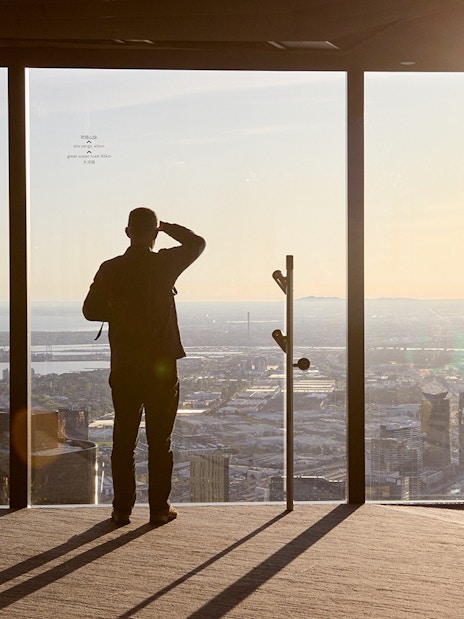 Person enjoying city view from Melbourne Skydeck at sunset, part of Max VR Experience.