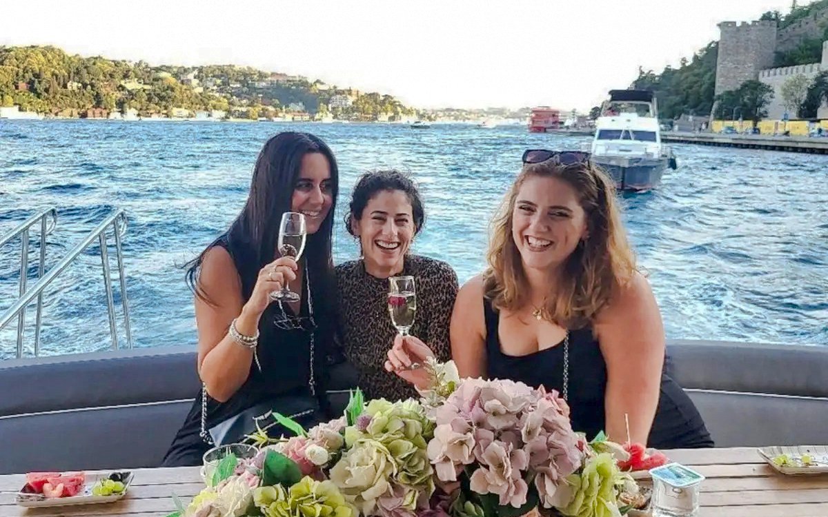 Tourists enjoying drinks on a luxury yacht during a Bosphorus private cruise.