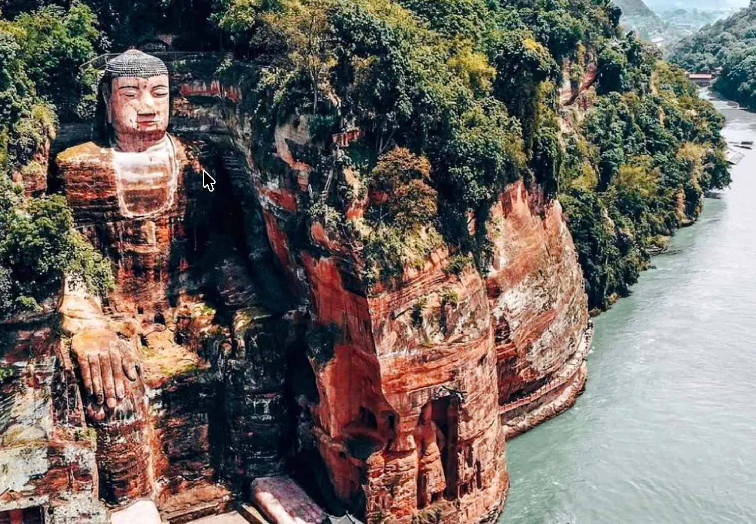 Leshan Giant Buddha carved into cliffside by river in Chengdu, China.
