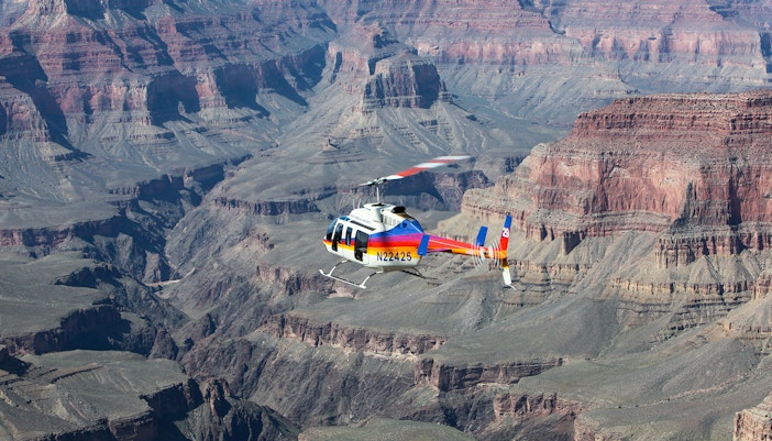 Aerial shot of a helicopter flying over the Grand Canyon