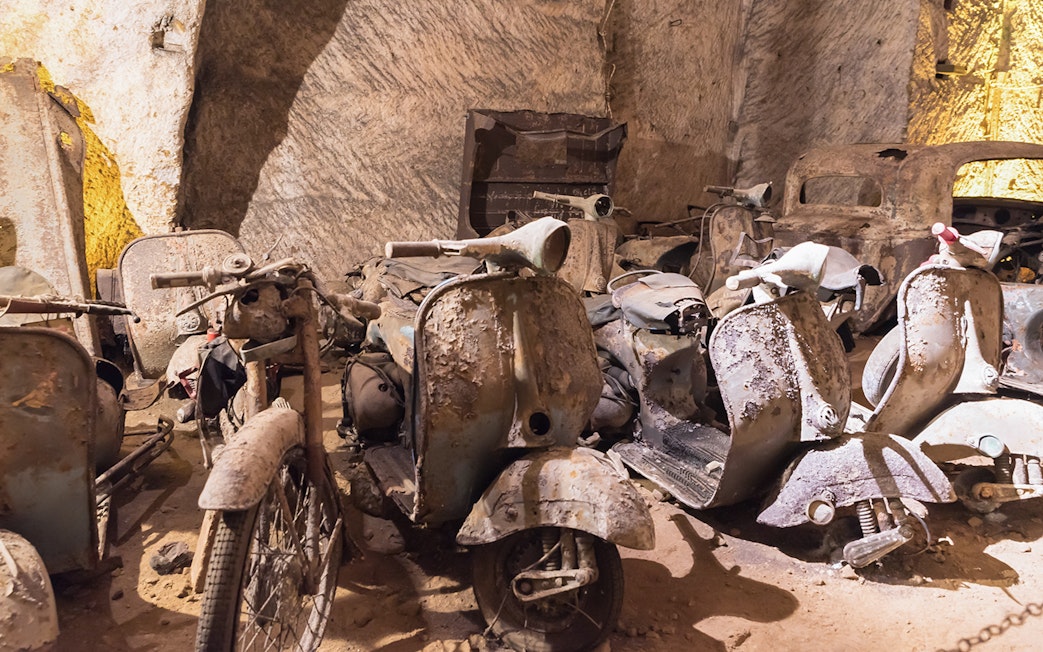 Abandoned scooters and cars in Naples Underground cave.