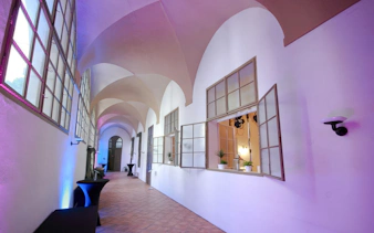 Hallway with arched ceilings and open windows in the Minorite Friary of St. James, Prague.