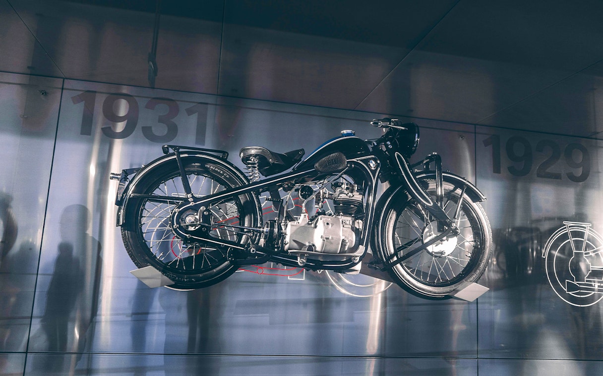 Vintage motorcycle display at a museum with 1931 in the background.
