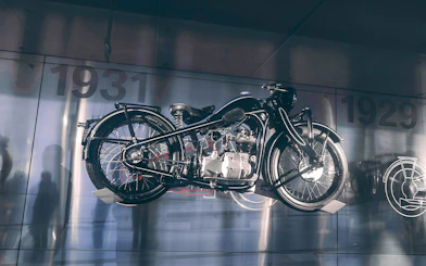 Vintage motorcycle display at a museum with 1931 in the background.