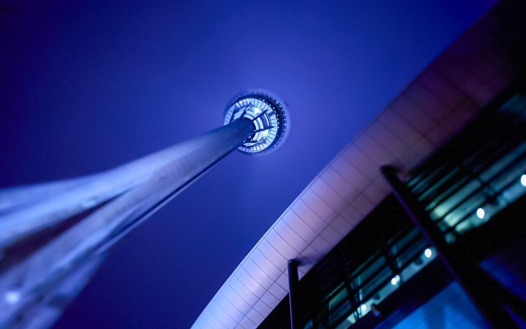 Perspective view of Macau Tower illuminated at night.
