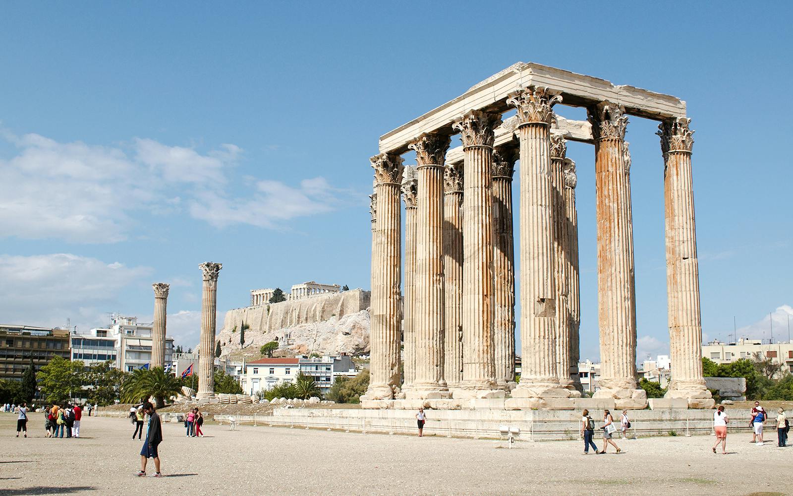 Temple of Olympian Zeus ruins in Athens with Acropolis in the background.