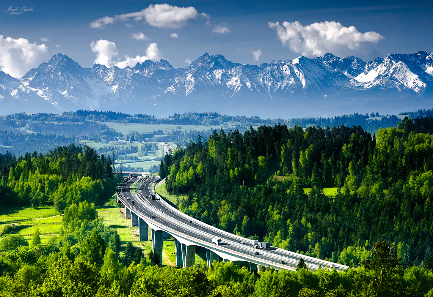 Highway through lush forest with Tatra Mountains in Zakopane, Poland, on a day trip from Krakow.
