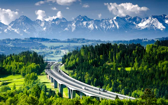 Highway through lush forest with Tatra Mountains in Zakopane, Poland, on a day trip from Krakow.
