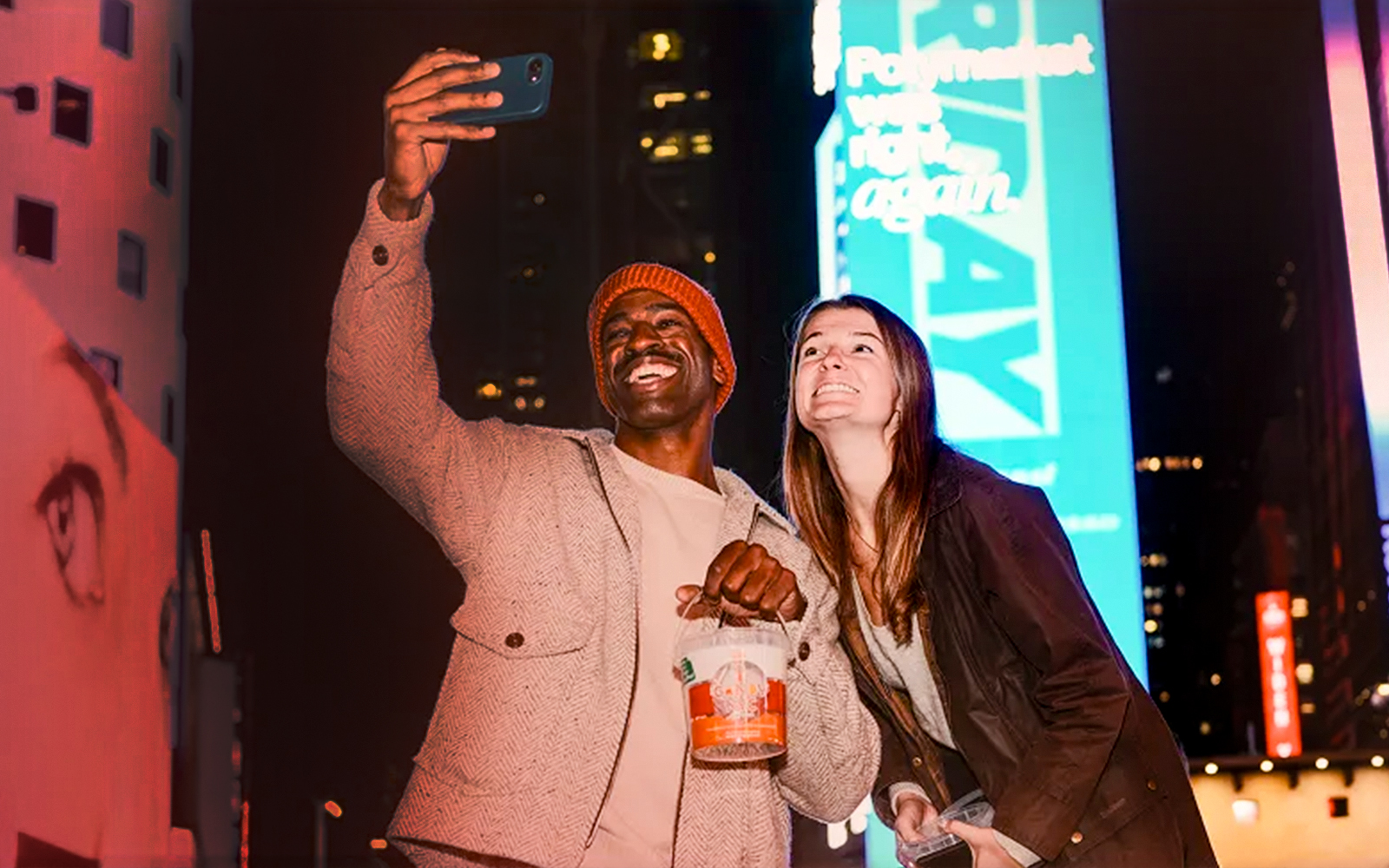 Couple taking a selfie in Times Square during the iCandy Experience in NYC.