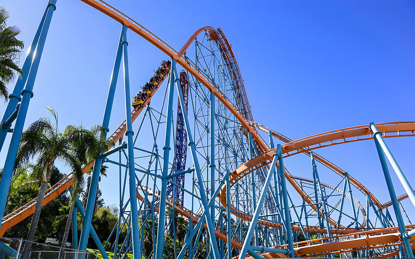 Roller coaster at Six Flags Magic Mountain with blue sky backdrop.
