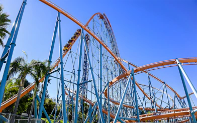 Roller coaster at Six Flags Magic Mountain with blue sky backdrop.