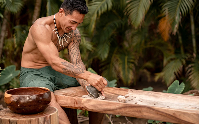 Man preparing traditional Hawaiian dish at Old Lahaina Luau, Maui.