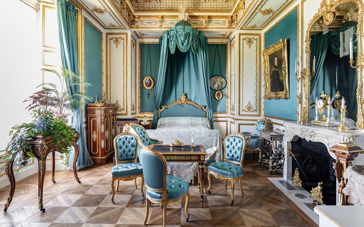 Chateau of Chantilly ornate room with antique furniture and decorative details.