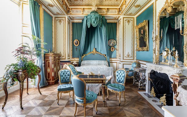 Chateau of Chantilly ornate room with antique furniture and decorative details.