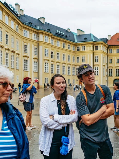 Guide explaining to visitors at Old Town Square, Prague.