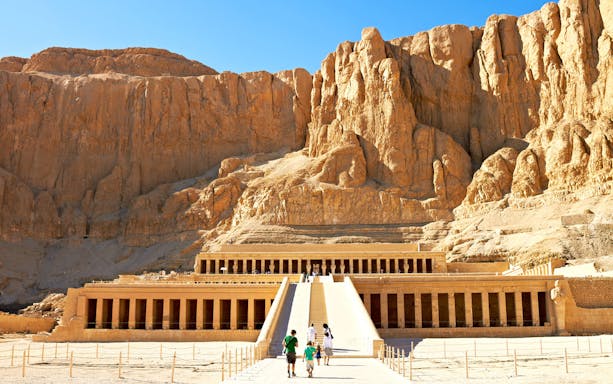 Valley of the Kings, Luxor, with tourists approaching the ancient temple entrance.