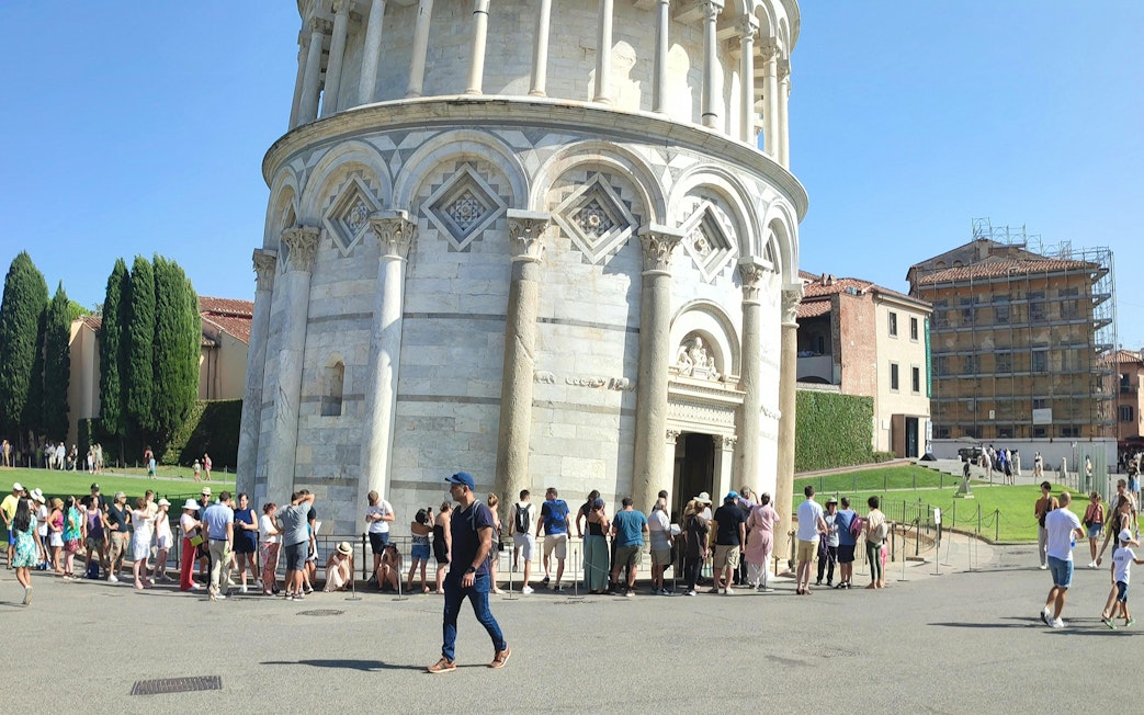 Tourists lined up to enter the Leaning Tower of Pisa, Italy.