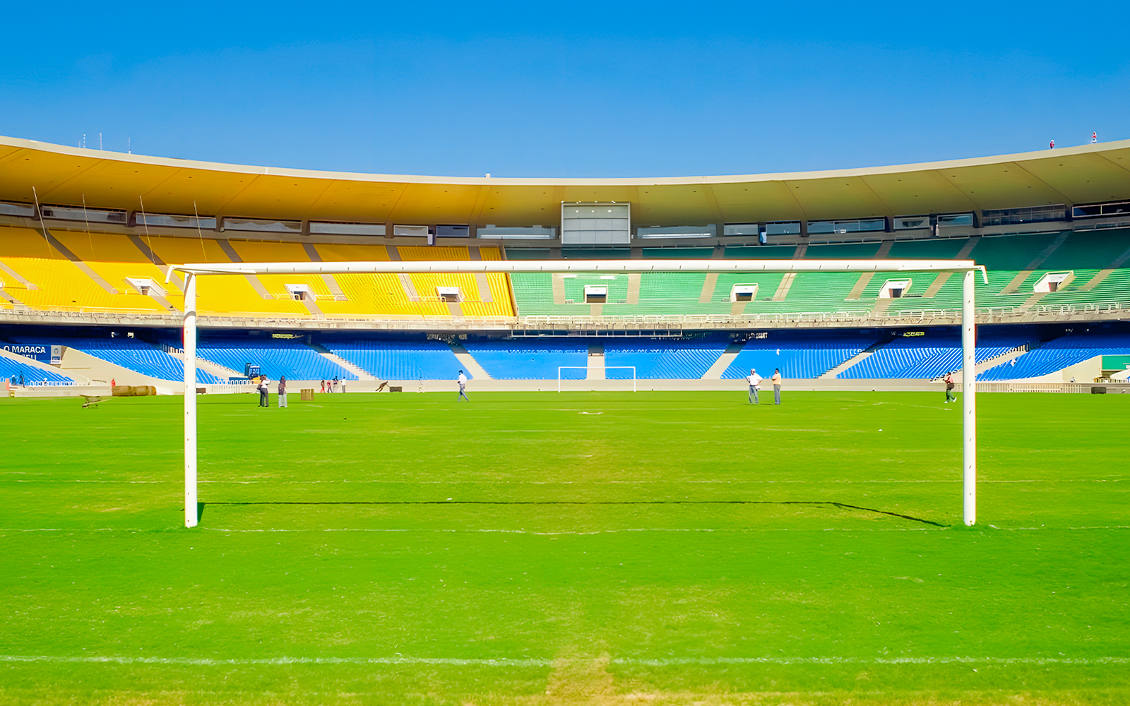 Maracanã Stadium field with goalposts and colorful seating, Rio de Janeiro, Brazil.