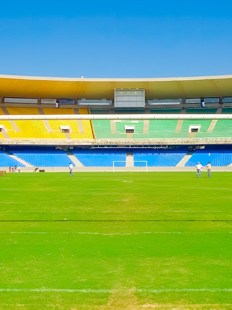 Maracanã Stadium field with goalposts and colorful seating, Rio de Janeiro, Brazil.