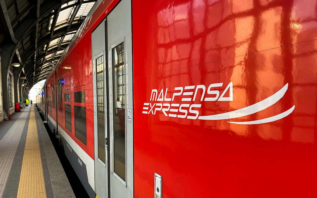 Malpensa Express train at a station platform in Milan, Italy.