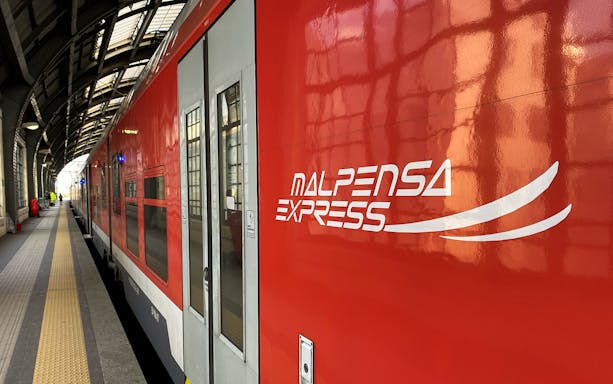Malpensa Express train at a station platform in Milan, Italy.