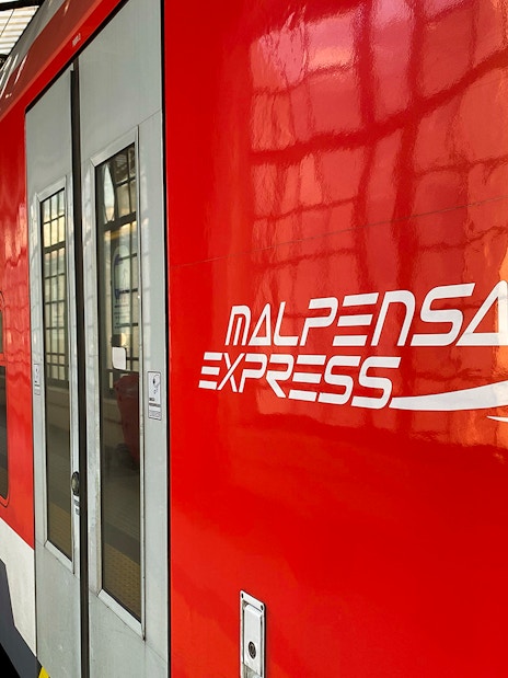 Malpensa Express train at Milan Cadorna Station platform.