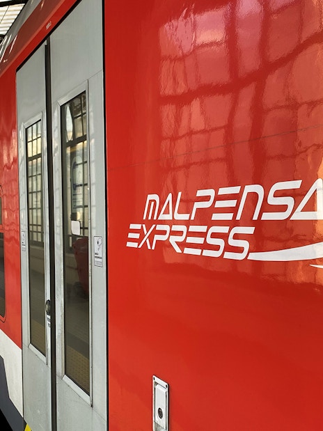Malpensa Express train at Milan Cadorna Station platform.