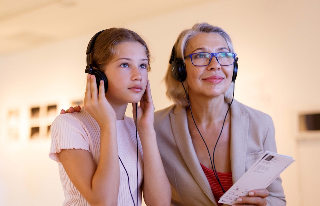 Women using Audio guide at Whales of Iceland Museum