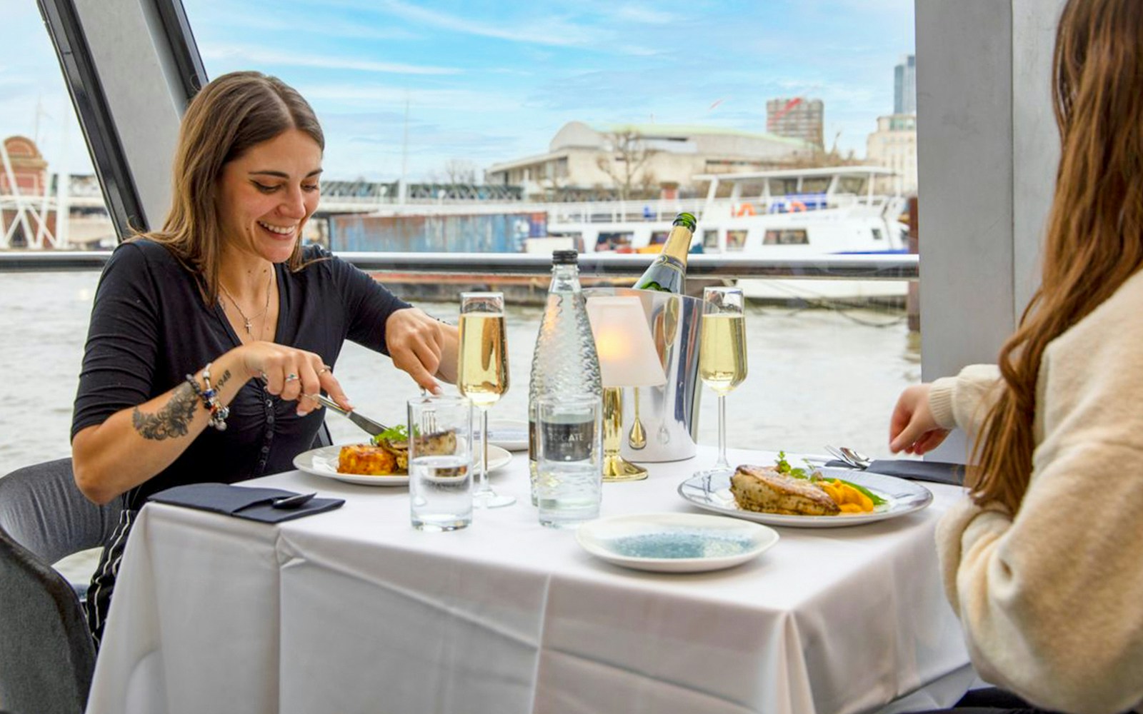 Woman enjoying 2-course meal on Thames River Lunch Cruise