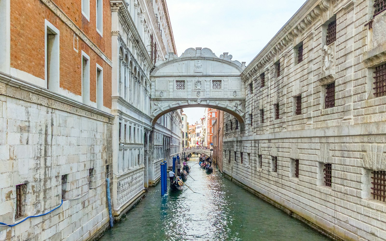 Gondolas passing under the Bridge of Sighs in Venice, Italy.