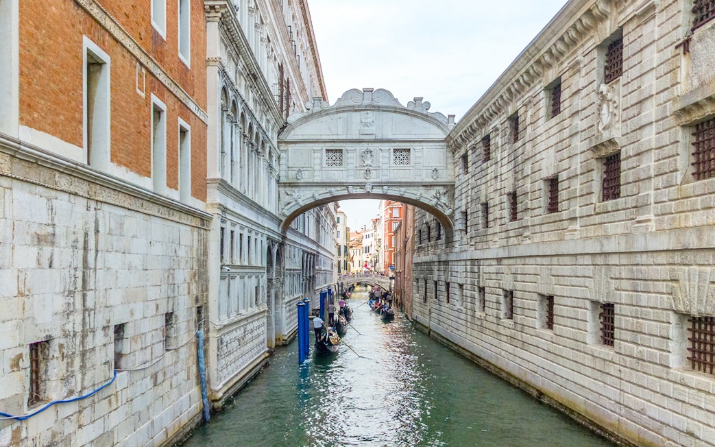 Gondolas passing under the Bridge of Sighs in Venice, Italy.
