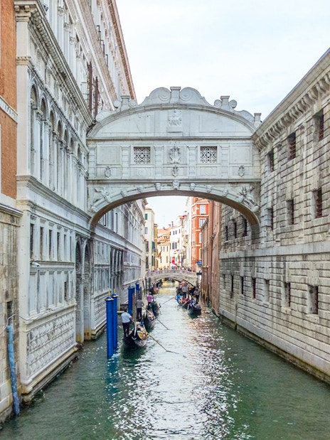 Gondolas passing under the Bridge of Sighs in Venice, Italy.