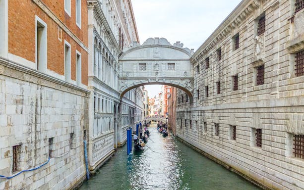 Gondolas passing under the Bridge of Sighs in Venice, Italy.