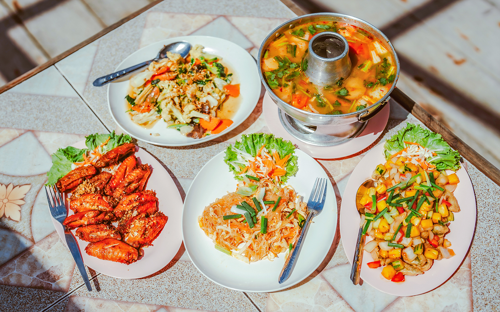 Thai dishes served on a table during a Krabi luxury longtail boat cruise.
