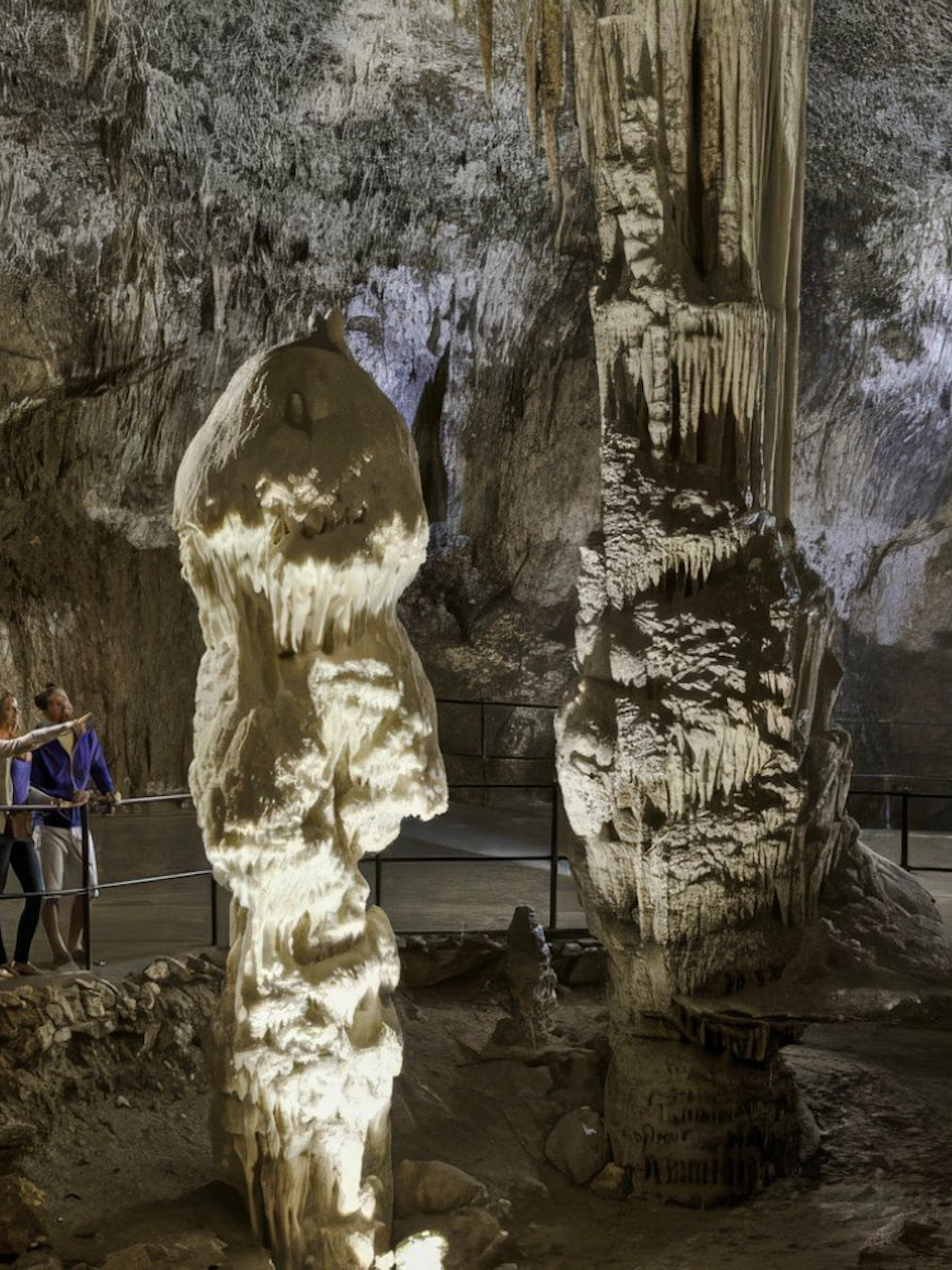 Guests exploring stalagmites in Postojna Cave, Slovenia.