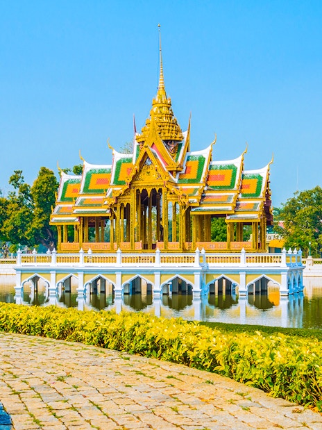 Bang Pa-In Royal Palace pavilion on a lake in Ayutthaya, surrounded by gardens.
