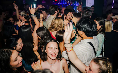 Crowd enjoying a lively club scene during Munich nightlife tour.