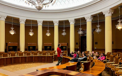 Tour group inside the Palace of Culture and Science, Warsaw, with guide speaking.