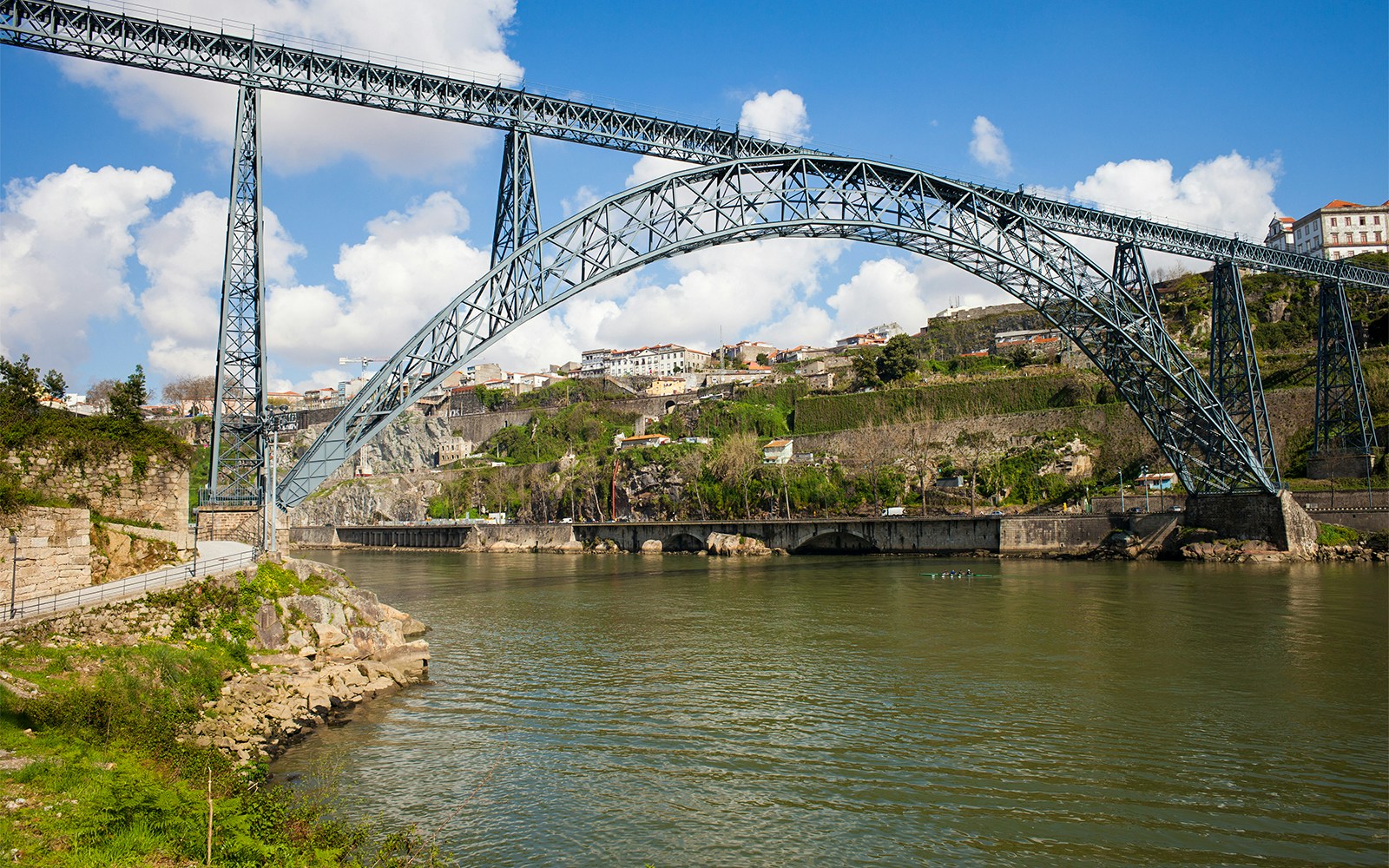 Dona Maria Bridge with hop-on hop-off bus in Porto, Portugal.