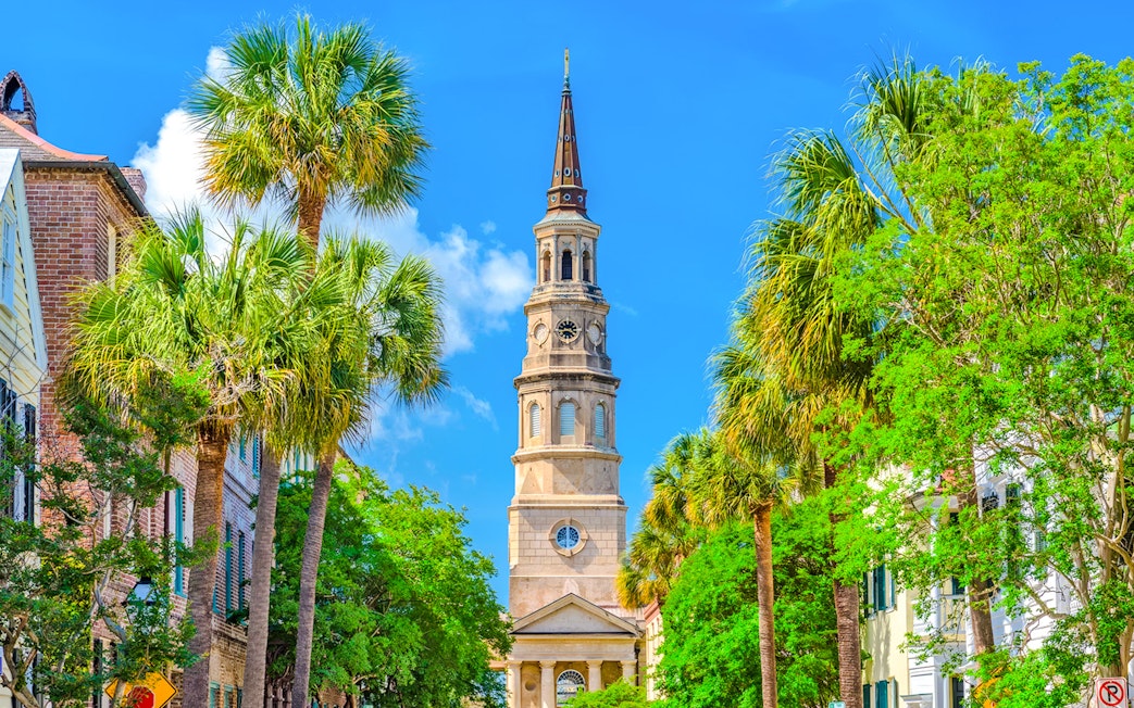 Charleston city tour featuring historic church steeple and palm trees.