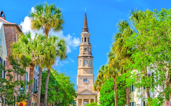 Charleston city tour featuring historic church steeple and palm trees.