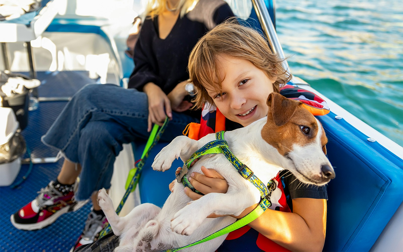 Child holding a dog on a Koblenz river cruise boat.