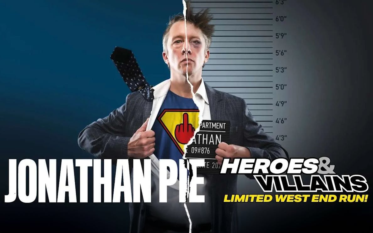 Jonathan Pie in split superhero and mugshot attire for Heroes and Villains show.