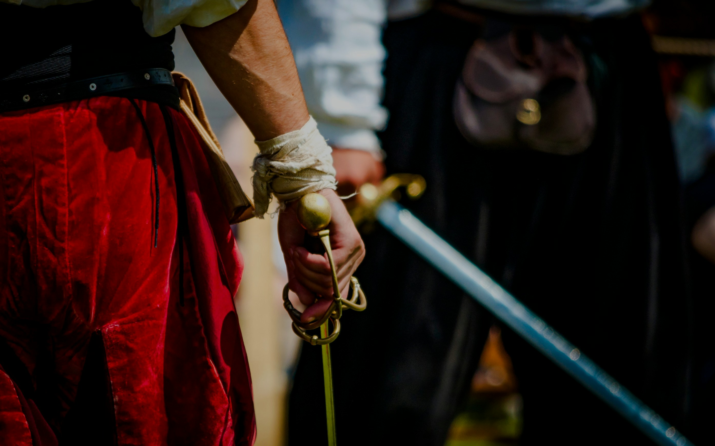 Pirate holding a sword during a reenactment event.