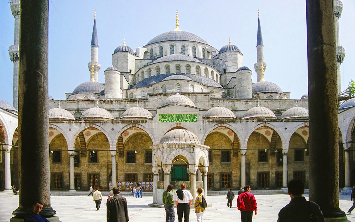 Blue Mosque courtyard with visitors, Istanbul, part of guided tour and skip-the-line tickets combo.