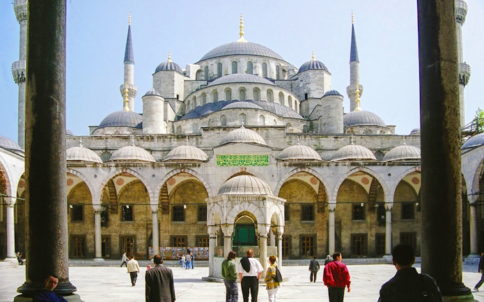 Blue Mosque courtyard with visitors, Istanbul, part of guided tour and skip-the-line tickets combo.