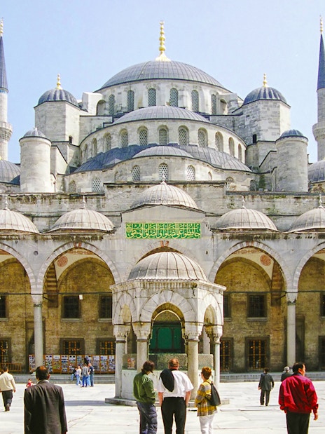 Blue Mosque courtyard with visitors, Istanbul, part of guided tour and skip-the-line tickets combo.